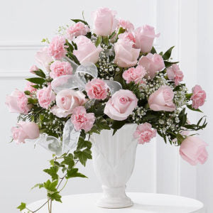 2 dozen pink roses in a vase