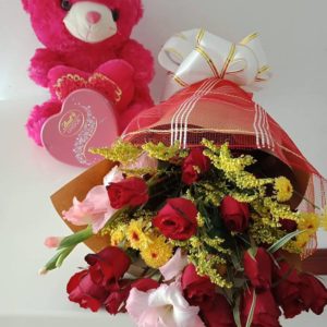 12 red roses with fillers in a bouquet and 8″ inches heartshape bear and lindt heartshape