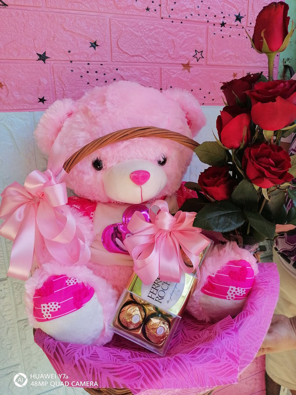 Beautiful pink Teddy with 8pcs Ferero Rocher and 6pcs Red Roses in a Basket